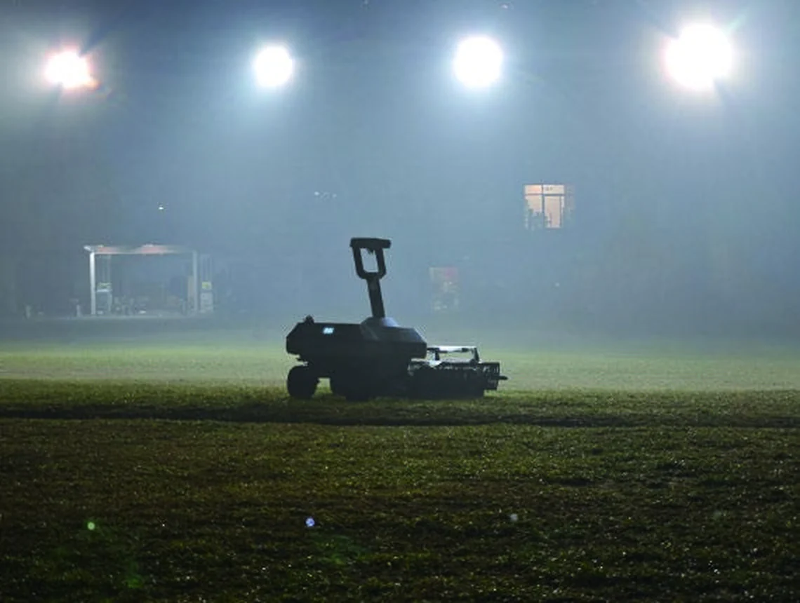 WayPick 2 collecting balls at night on a floodlit driving range in mist