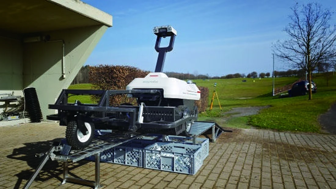 The WayPick 2 unloading station standing on paving beside a driving range